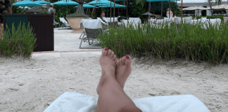 My Kid-Free Anniversary Vacation A woman's feet as she relaxes at the beach resort.