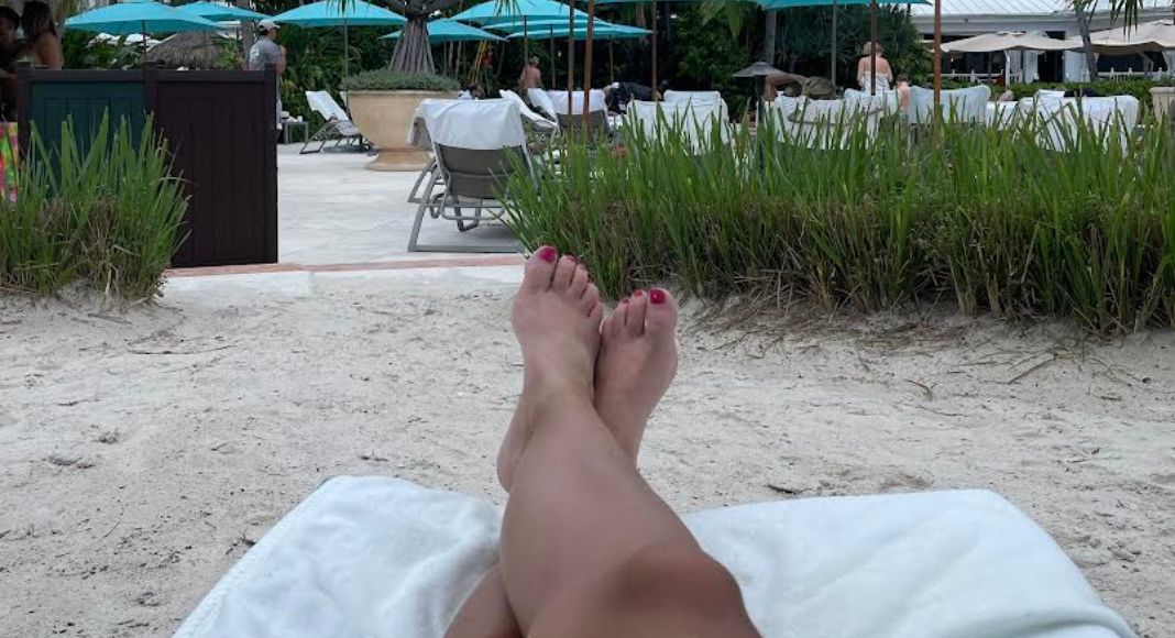 A woman's feet as she relaxes at the beach resort.