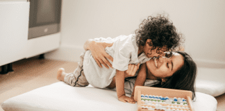 Changing the Narrative on Mom Guilt A mom cuddling her toddler son.