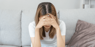 I’ve Attempted Suicide and Here’s What I Want You to Know A woman with her head in her hands.
