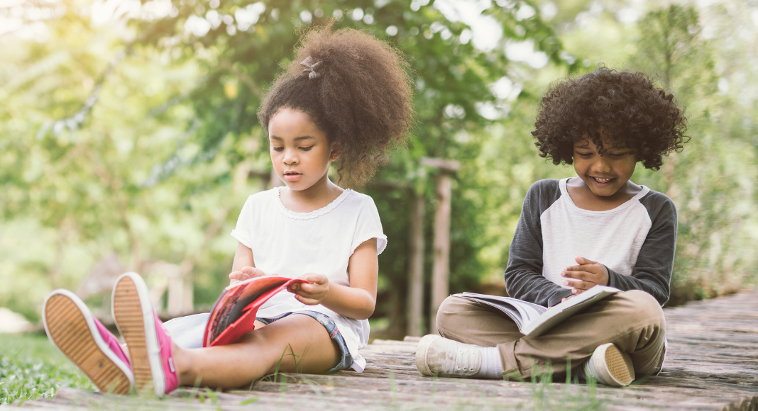 Kids reading during the summer on a dock.