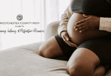 A pregnant woman holding her belly for the pregnancy, infancy, and postpartum guide.