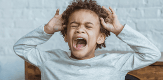 A kid playing the crying game having a tantrum.