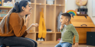 Too Smart to Deserve to Speak? A child working with a speech pathologist.