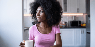 A woman drinking coffee alone in the morning.