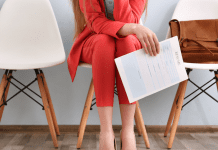 A woman holding a resume for a job interview.