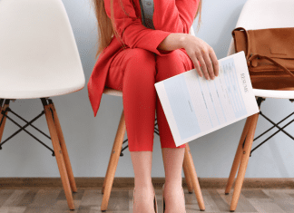 A woman holding a resume for a job interview.