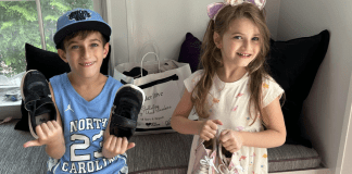 Children donating shoes to a local nonprofit.