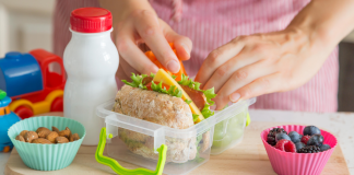 Ditch Those Boring School Lunches This Year With These Easy Tips A mom packing a school lunch.