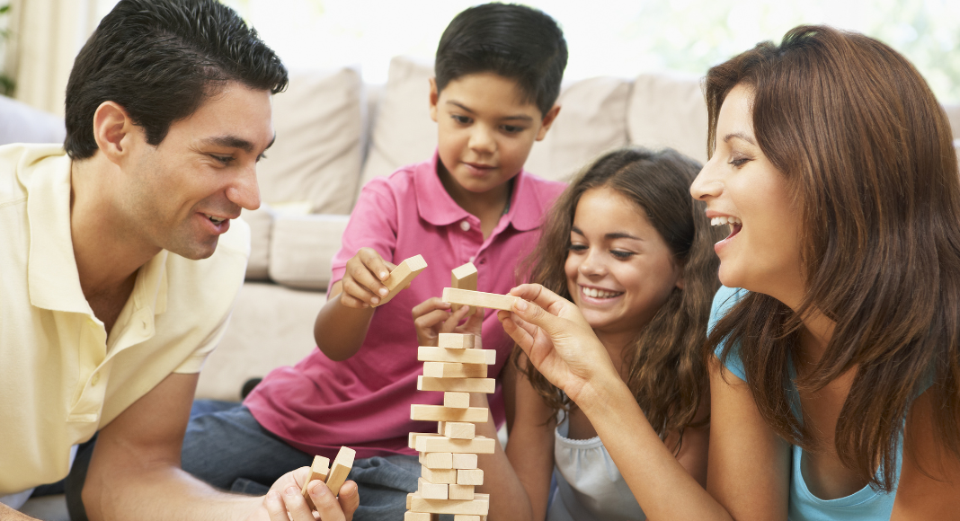 A family playing Jenga to slow down over the week.