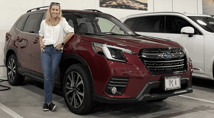 Jess at the Subaru White Plains dealership standing next to a 2023 Forester