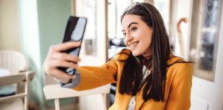 Not Always as It Seems A woman taking a selfie for a social media post.