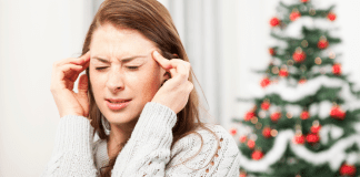 4 Tips to Survive the Holiday Chaos A stressed mom holding her head.