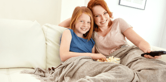 It’s Twixmas Time A mother and daughter under a blanket watching a movie.