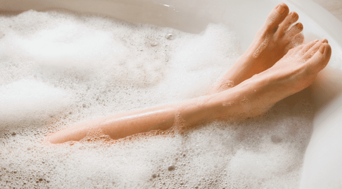A woman's feet in a bubble bath.