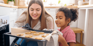 A mom baking cookies with her daughter.