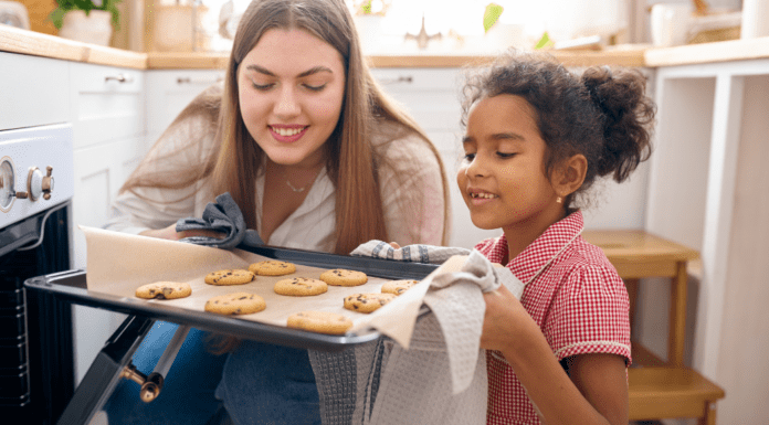 A mom baking cookies with her daughter.
