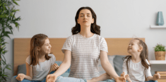 Nurturing Hearts and Taking Care of Your Own A mom meditating with her daughters.