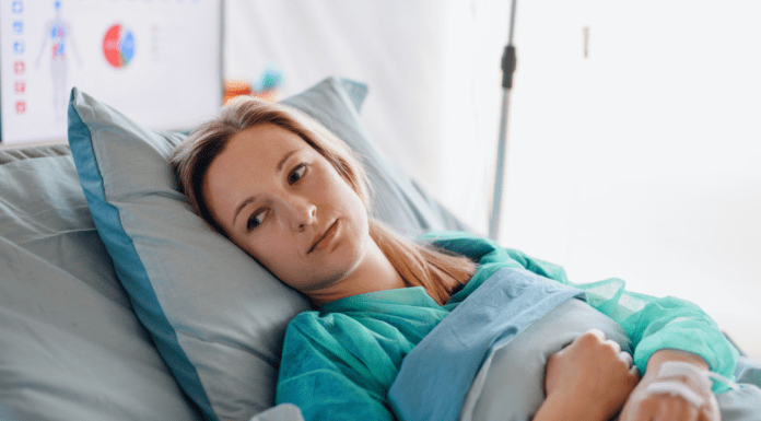 A woman laying in bed after surgery.