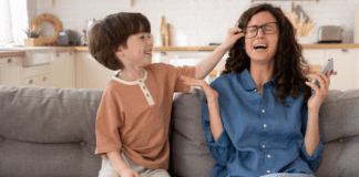 A son annoying his mother.