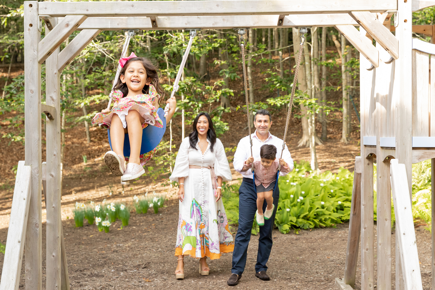A family photo session on a swing set. 