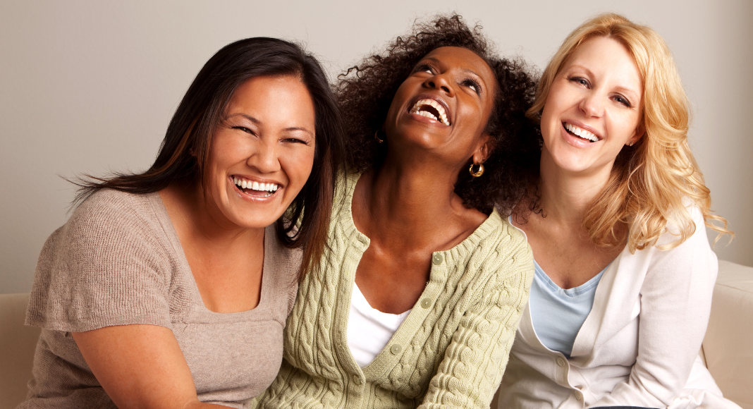 Three women smiling.