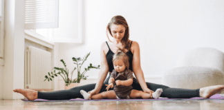Making Time for Fitness: 20-Minute Workouts A mom doing yoga holding her toddler.