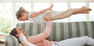 The Idea of Happily Ever After A mom holding up her daughter.
