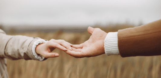 Reaching out to hold hands.