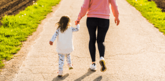 It Takes a County: Meet Annie A woman walking down the sidewalk holding her daughter's hand.
