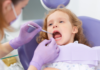 A girl getting a dental exam.