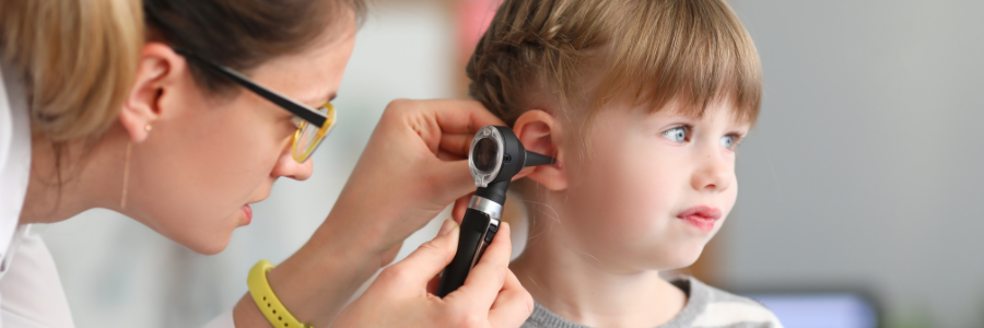 A doctor looking in a child's ear.