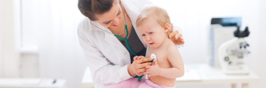 A doctor listening to a child's chest.
