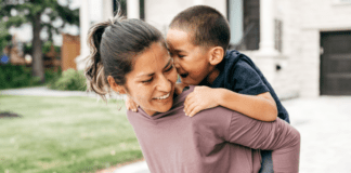 A woman carrying her son on her back.