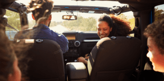 A family in a car on a road trip.