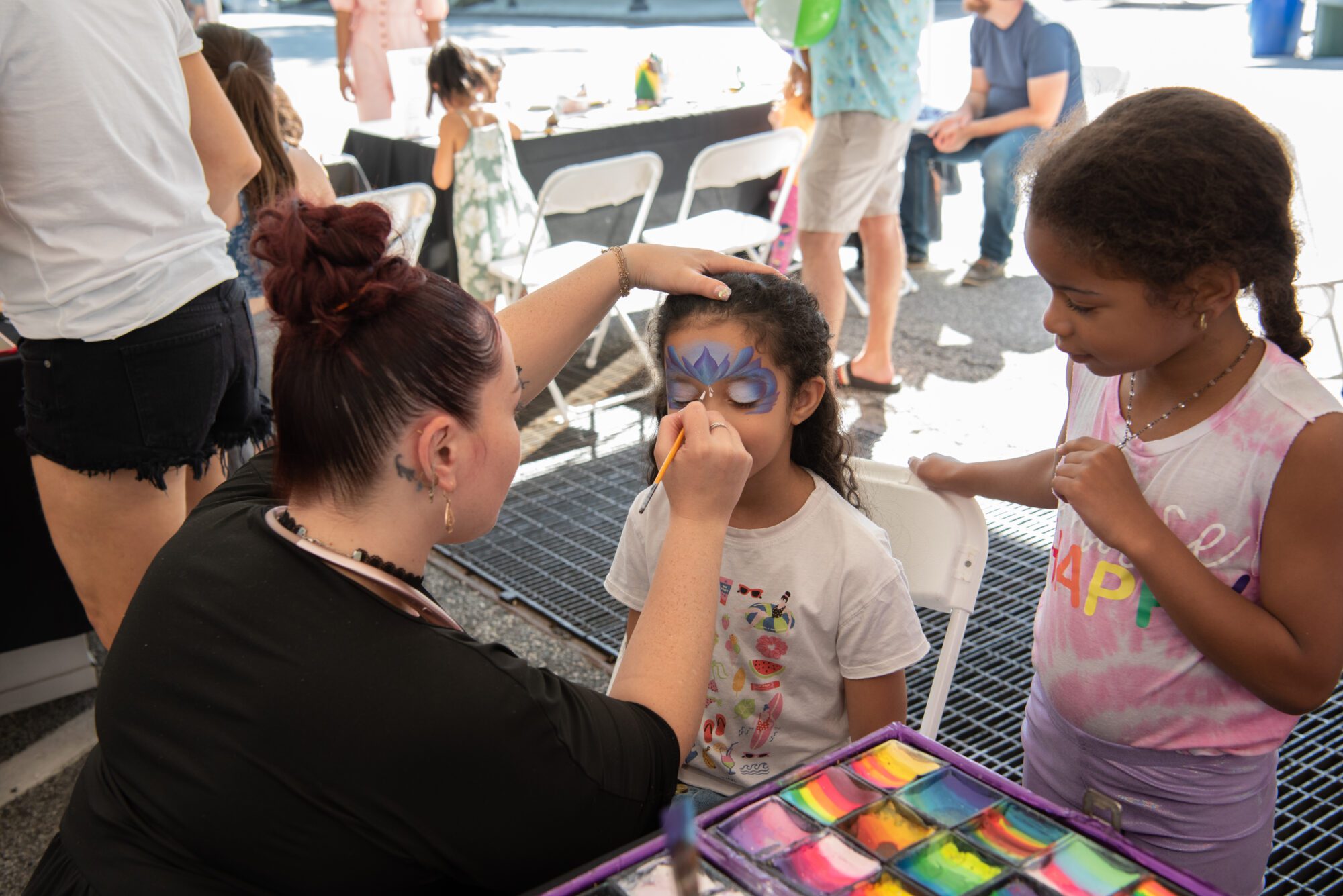 A child getting her face painted. 