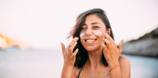 Don’t Fry Friday A woman putting sunscreen on her face.