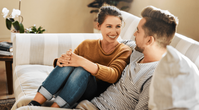 A couple talking on the couch.