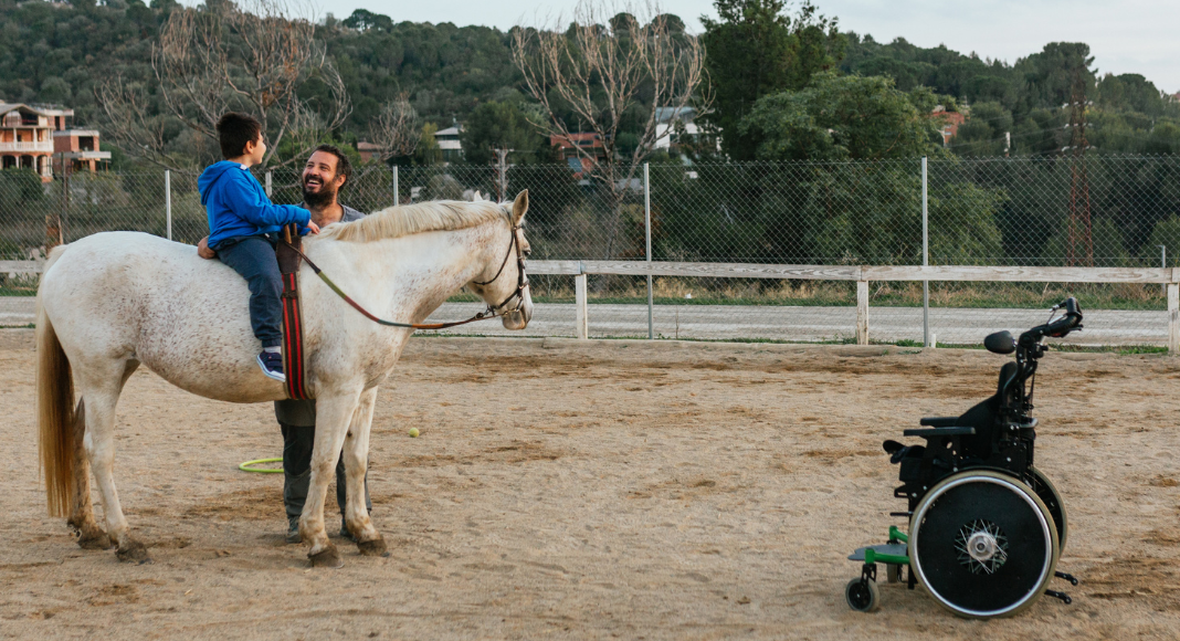A special needs child riding a horse. 