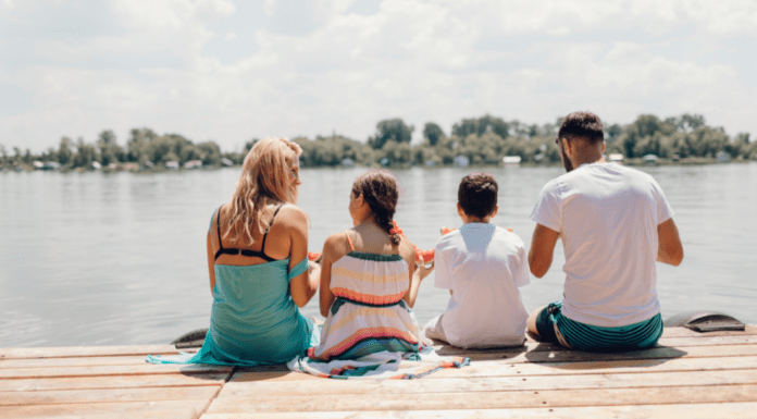 Fun and Affordable Things to Try This Summer A family sitting on a dock in summer.