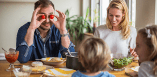 Games for Selective Eaters A dad holding cherry tomatoes in front of his eyes.