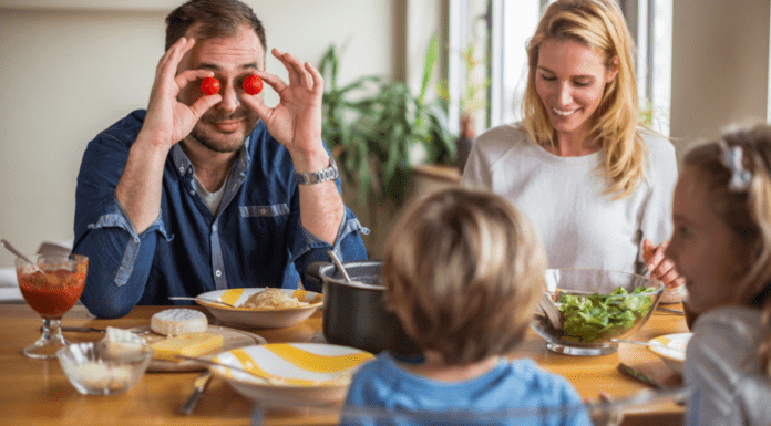 Games for Selective Eaters A dad holding cherry tomatoes in front of his eyes.