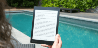 The Top 10 Books for Moms to Enjoy This Summer A woman reading a Kindle by the pool.