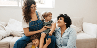A family sitting on the couch.