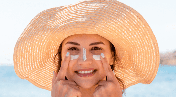 Embrace the Glow: How to Keep Your Skin Healthy This Summer A woman applying sunscreen to her face.