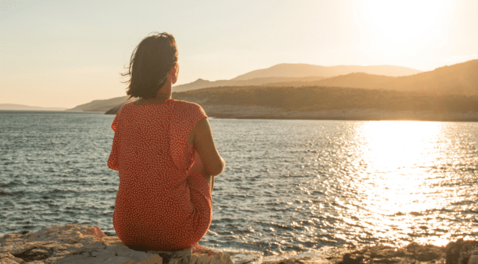 The Long View of Motherhood: Meet Maura A woman sitting and admiring the view of the ocean.