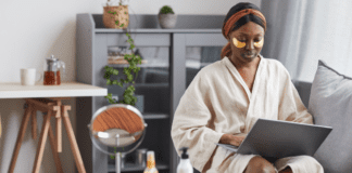A mom on her computer with an eye mask.