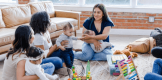 Why Moms’ Groups Matter: Building Community After Baby Women at a moms' group with their children.