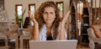 A woman frustrated while looking at her computer.