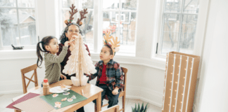 A family decorating a small tree.